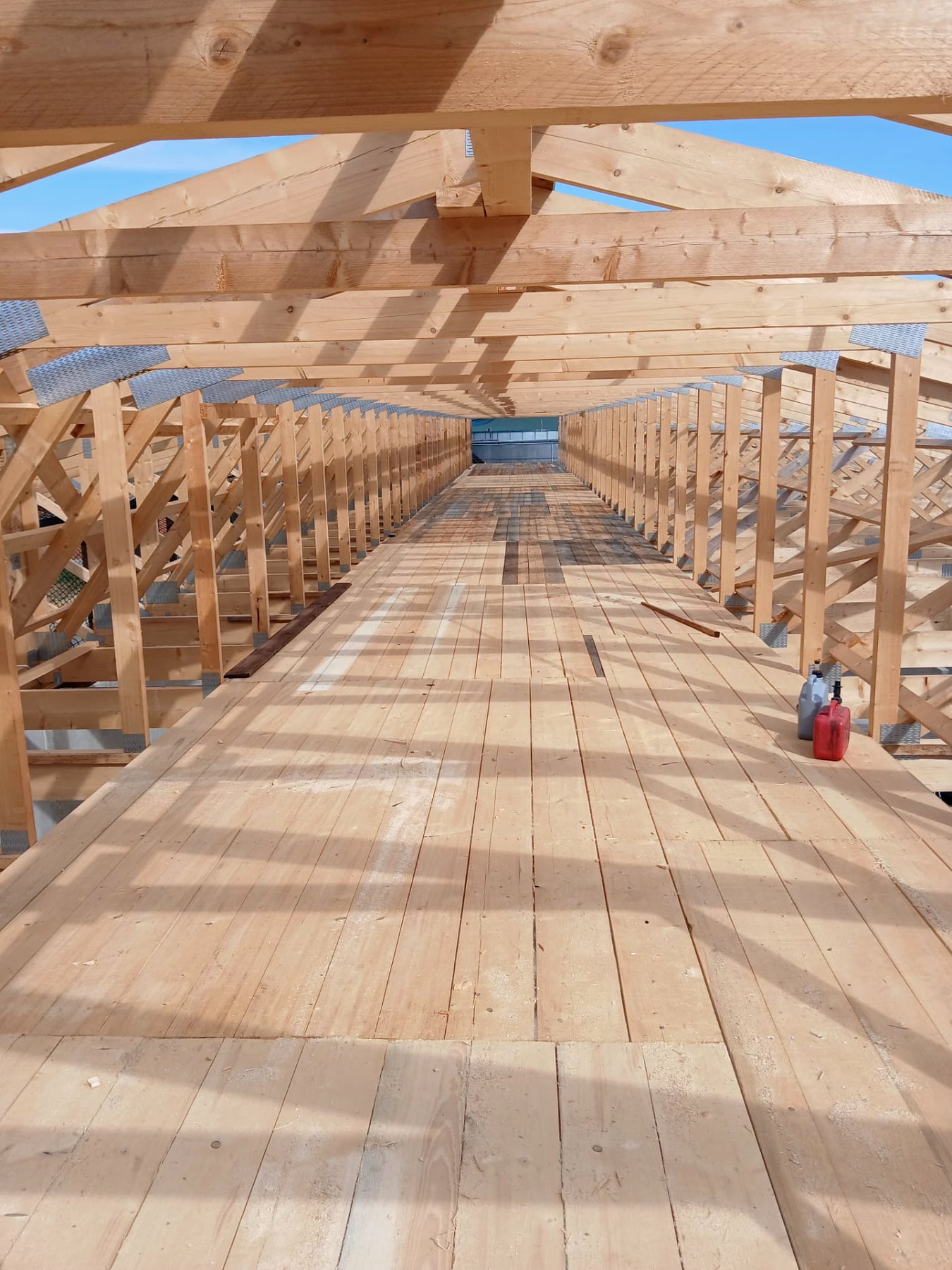 Blick durch einen neu errichteten Dachstuhl mit Holzbindern